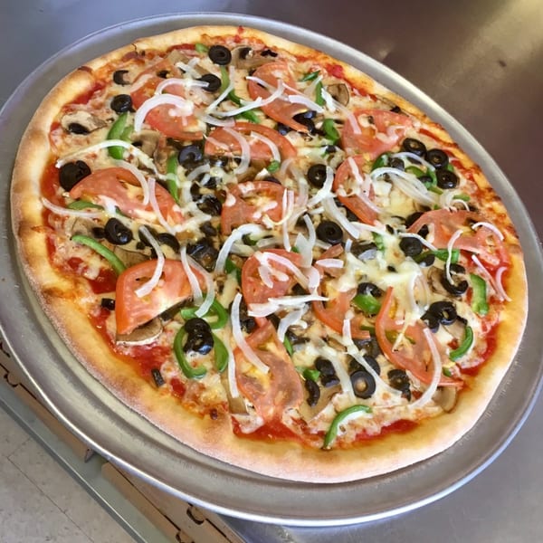 Enzo's Pizzeria's fresh vegetable pizza with tomatoes, onions, olives, mushrooms, and green peppers.