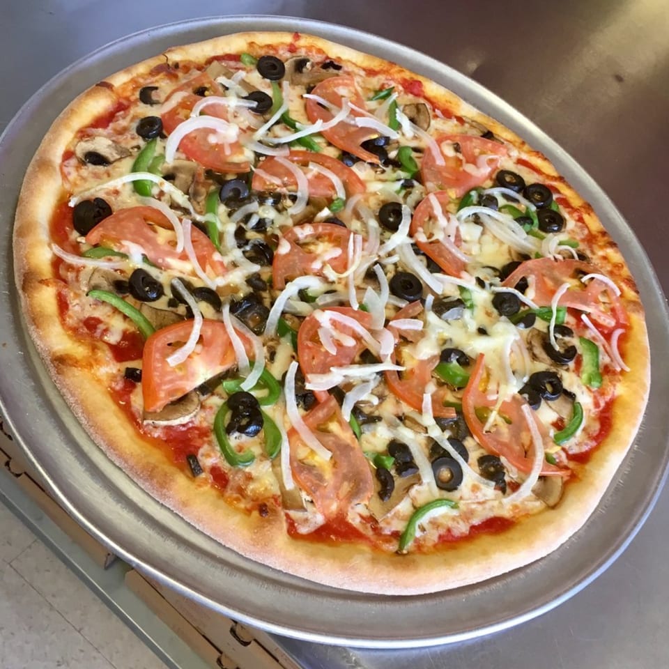 Enzo's Pizzeria's fresh vegetable pizza with tomatoes, onions, olives, mushrooms, and green peppers.